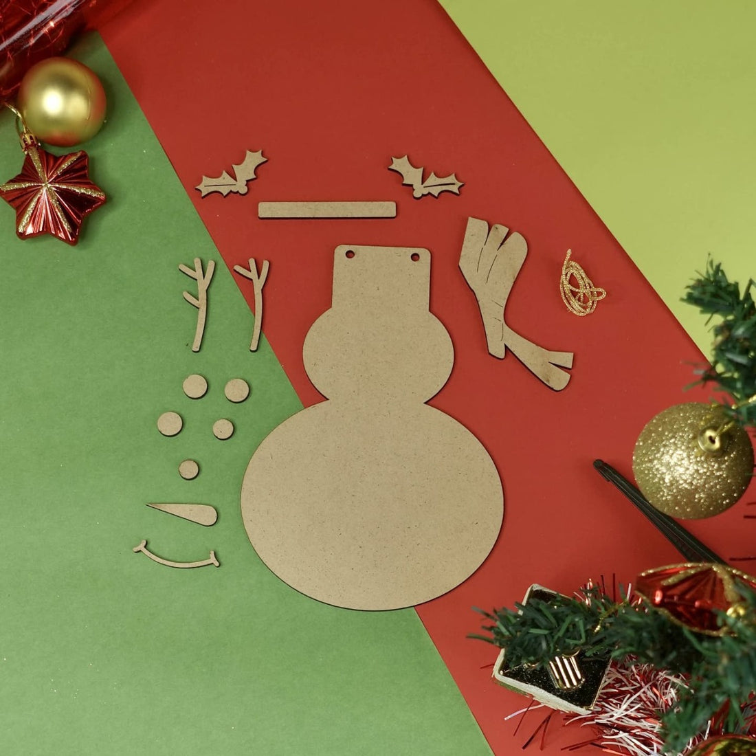 DIY Snowman with a blue collar and carrot nose on a decorated christmas tree